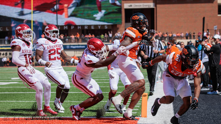 Sep 7, 2024; Stillwater, Oklahoma, USA; Oklahoma State Cowboys running back Ollie Gordon II (0) steps into the end zone for a touchdown during the second overtime against the Arkansas Razorbacks at Boone Pickens Stadium. Mandatory Credit: William Purnell-Imagn Images