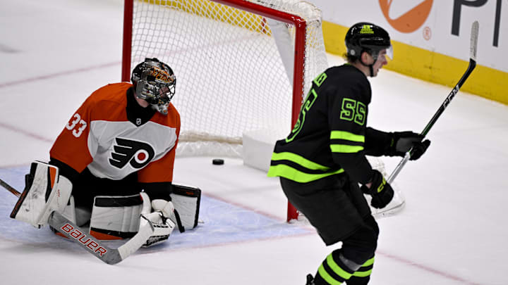 Mar 22, 2025; Dallas, Texas, USA; Dallas Stars defenseman Thomas Harley (55) scores the game-winning goal against Philadelphia Flyers goaltender Samuel Ersson (33) during the overtime period at the American Airlines Center. Mandatory Credit: Jerome Miron-Imagn Images