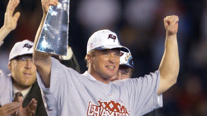 Tampa Bay Buccaneers head coach Jon Gruden holds up the Vince Lombardi Trophy after winning Super Bowl XXXVIII
