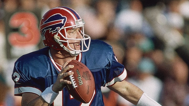 Jan 31, 1993; Pasadena, CA, USA; FILE PHOTO; Buffalo Bills quarterback Jim Kelly (12) scrambles with the ball against the Dallas Cowboys during Super Bowl XXVII at the Rose Bowl. The Cowboys defeated the Bills 52-17. Mandatory Credit: James D. Smith-USA TODAY Sports