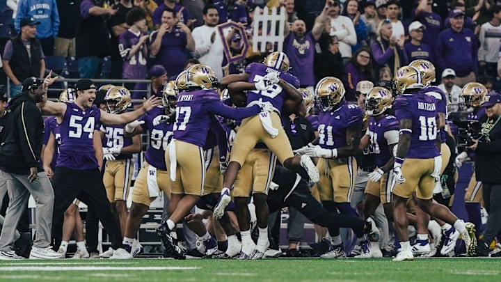 And injured Drew Fowler (54) watches as the defense celebrates Khmori House's interception against Northwestern.