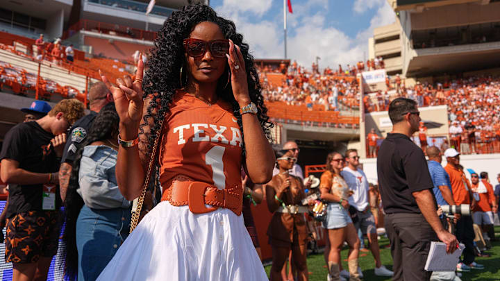 Loreal Sarkisian, wife of Texas head coach Steve Sarkisian, holds up the sign of the horns in the endzone before the game at Royal Memorial Stadium. Loreal Sarkisian, wife of Texas head coach Steve Sarkisian, holds up the sign of the horns in the endzone before the game at Royal Memorial Stadium.