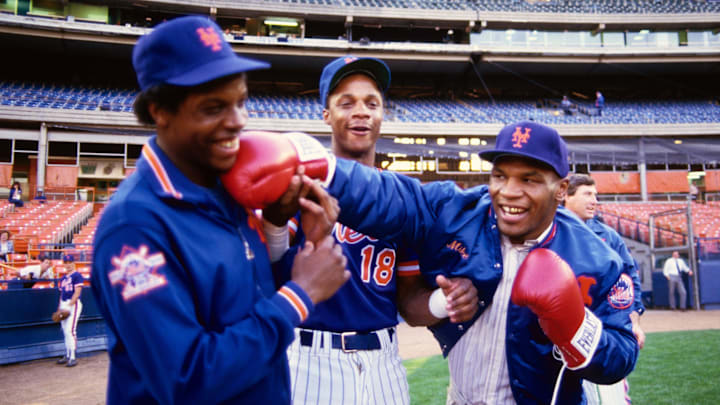 1990; Flushing, NY, USA; FILE PHOTO; New York Mets pitcher Dwight Gooden and right fielder Darryl Strawberry (18) joke around on the field with boxer Mike Tyson before a game at Shea Stadium. 1990; Flushing, NY, USA; FILE PHOTO; New York Mets pitcher Dwight Gooden and right fielder Darryl Strawberry (18) joke around on the field with boxer Mike Tyson before a game at Shea Stadium.