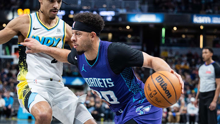 Apr 2, 2025; Indianapolis, Indiana, USA; Charlotte Hornets guard Seth Curry (30) dribbles the ball while Indiana Pacers guard Andrew Nembhard (2) defends in the first half at Gainbridge Fieldhouse. Mandatory Credit: Trevor Ruszkowski-Imagn Images