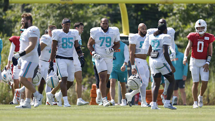 Miami Dolphins offensive tackle Larry Borom (79) walks on the field during joint training camp practice with the Chicago Bears ahead of the preseason opener.
