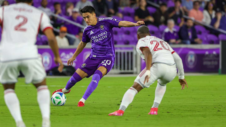 Mar 1, 2025; Orlando, Florida, USA; Orlando City defender Alex Freeman (30) handles the ball in front of Toronto FC midfielder Deybi Flores (20) at Inter&Co Stadium. Mandatory Credit: Mike Watters-Imagn Images