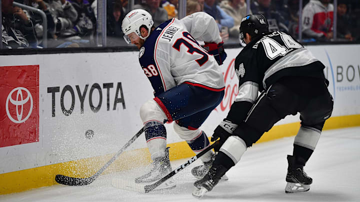 Blue Jackets forward Boone Jenner tries to make a play in front of Kings defenseman Mikey Anderson.