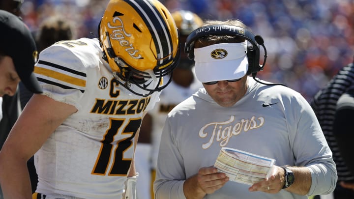 Oct 8, 2022; Gainesville, Florida, USA; Missouri Tigers head coach Eliah Drinkwitz and quarterback Brady Cook (12) talk against the Florida Gators during the second half at Ben Hill Griffin Stadium. Mandatory Credit: Kim Klement-USA TODAY Sports Oct 8, 2022; Gainesville, Florida, USA; Missouri Tigers head coach Eliah Drinkwitz and quarterback Brady Cook (12) talk against the Florida Gators during the second half at Ben Hill Griffin Stadium. Mandatory Credit: Kim Klement-USA TODAY Sports