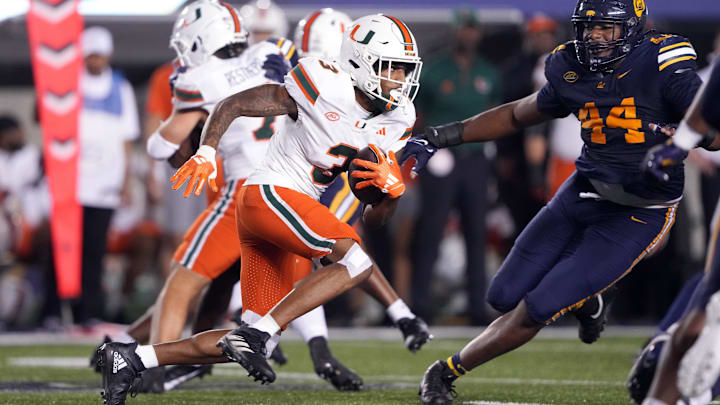 Oct 5, 2024; Berkeley, California, USA; Miami Hurricanes wide receiver Jacolby George (3) runs after a catch against California Golden Bears linebacker Xavier Carlton (44) during the third quarter at California Memorial Stadium. Mandatory Credit: Darren Yamashita-Imagn Images