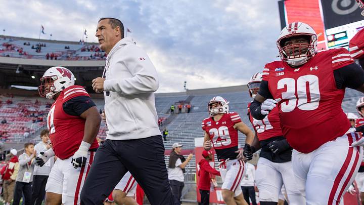 Oct 24, 2026; Madison, Wisconsin, USA; Wisconsin Badgers head coach Luke Fickell runs onto the field with his team for warmups before the game against the USC Trojans at Camp Randall Stadium. Mandatory Credit: Anthony Wahl-Imagn Images