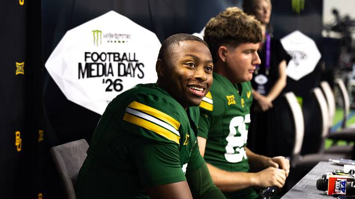 Baylor quarterback DJ Lagway (left) and tight end Matthew Klopfenstein meet with reporters during Big 12 Football Media Days, answering questions ahead of the 2026 college football season. Baylor quarterback DJ Lagway (left) and tight end Matthew Klopfenstein meet with reporters during Big 12 Football Media Days, answering questions ahead of the 2026 college football season.