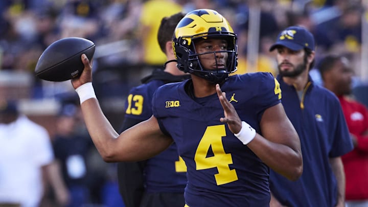 Aug 31, 2024; Ann Arbor, Michigan, USA;  Michigan Wolverines quarterback Jayden Denegal (4) warms up before the game against the Fresno State Bulldogs at Michigan Stadium. Mandatory Credit: Rick Osentoski-Imagn Images