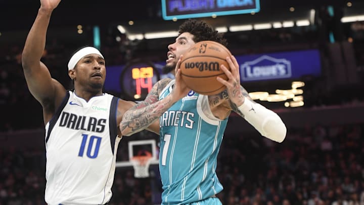 Charlotte Hornets guard LaMelo Ball (1) drives against Dallas Mavericks guard Brandon Williams