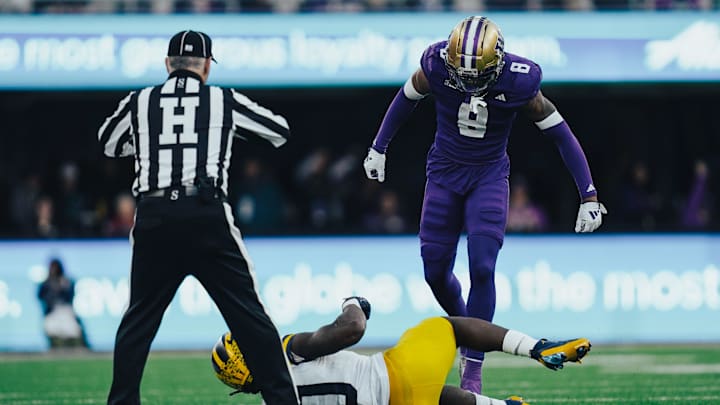Cam Broussard stands over a fallen Michigan player in menacing fashion. Cam Broussard stands over a fallen Michigan player in menacing fashion.