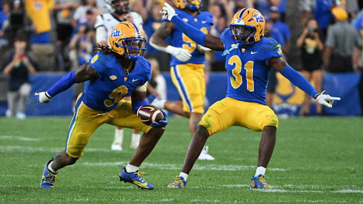 Sep 14, 2024; Pittsburgh, Pennsylvania, USA; Pittsburgh Panthers linebacker Kyle Louis celebrates with linebacker Rasheem Biles (31) after intercepting West Virginia Mountaineers quarterback Garrett Greene (6) in the fourth quarter at Acrisure Stadium. Mandatory Credit: Barry Reeger-Image Images