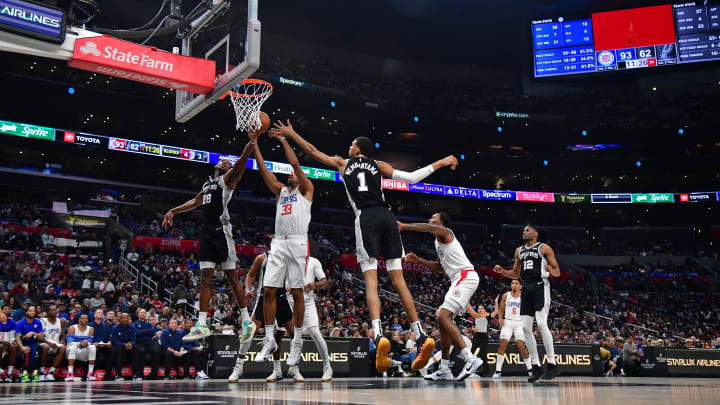 Oct 29, 2023; Los Angeles, California, USA; San Antonio Spurs center Charles Bassey (28) and center Victor Wembanyama (1) play for the rebound against Los Angeles Clippers forward Nicolas Batum (33) during the second half at Crypto.com Arena. Mandatory Credit: Gary A. Vasquez-USA TODAY Sports Oct 29, 2023; Los Angeles, California, USA; San Antonio Spurs center Charles Bassey (28) and center Victor Wembanyama (1) play for the rebound against Los Angeles Clippers forward Nicolas Batum (33) during the second half at Crypto.com Arena. Mandatory Credit: Gary A. Vasquez-USA TODAY Sports