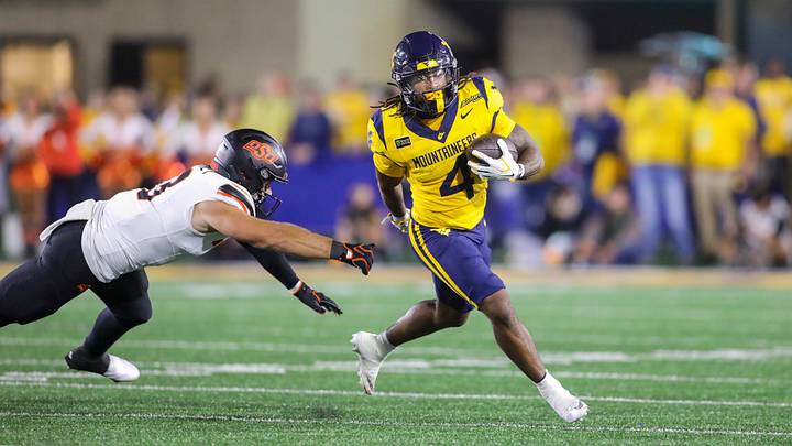 Sep 26, 2026; Morgantown, West Virginia, USA; West Virginia Mountaineers running back Cam Cook (4) runs the ball during the first quarter against the Oklahoma State Cowboys at Milan Puskar Stadium. Mandatory Credit: Ben Queen-Imagn Images Sep 26, 2026; Morgantown, West Virginia, USA; West Virginia Mountaineers running back Cam Cook (4) runs the ball during the first quarter against the Oklahoma State Cowboys at Milan Puskar Stadium. Mandatory Credit: Ben Queen-Imagn Images