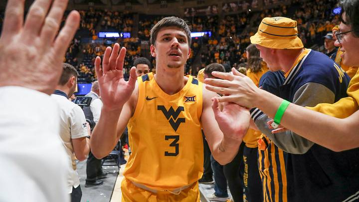 Jan 13, 2024; Morgantown, West Virginia, USA; West Virginia Mountaineers guard Kerr Kriisa (3) celebrates with students after defeating the Texas Longhorns at WVU Coliseum. Mandatory Credit: Ben Queen-USA TODAY Sports