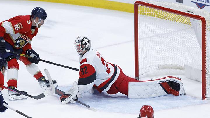 Dec 19, 2025; Sunrise, Florida, USA;  Carolina Hurricanes goaltender Brandon Bussi (32) blocks a shot by Florida Panthers center Sam Bennett (9) during the second period at Amerant Bank Arena. Mandatory Credit: Rhona Wise-Imagn Images