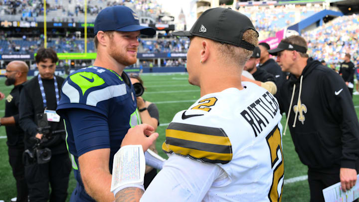 Sep 21, 2025; Seattle, Washington, USA; Seattle Seahawks quarterback Sam Darnold (14) and New Orleans Saints quarterback Spencer Rattler (2) shake hands after the game at Lumen Field. Mandatory Credit: Steven Bisig-Imagn Images