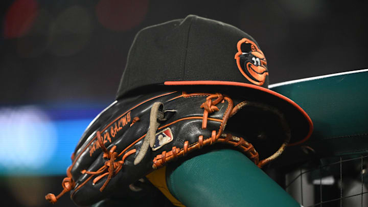 May 8, 2024; Washington, District of Columbia, USA; A Baltimore Orioles hat and glove rest on the dugout rail during a game against the Washington Nationals at Nationals Park.