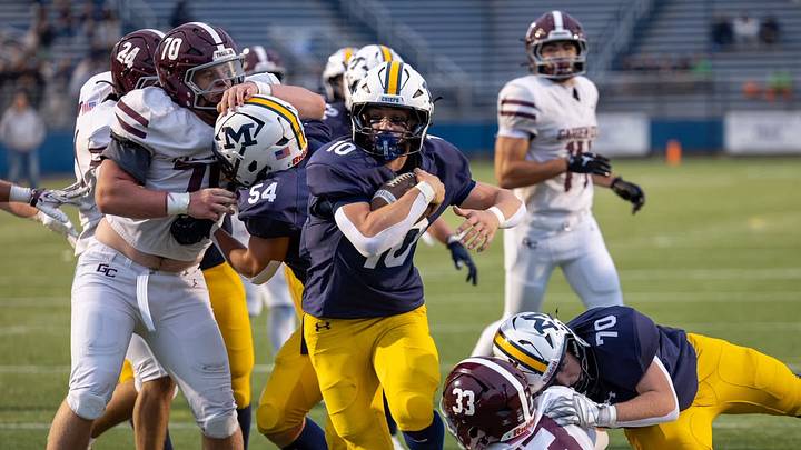 Massapequa's Justin Farrell (10) runs it up the middle for an 8-yard touchdown against Garden City on Monday. The Chiefs beat the Trojans, 21-14, to snap Garden City's 68-game win streak.
