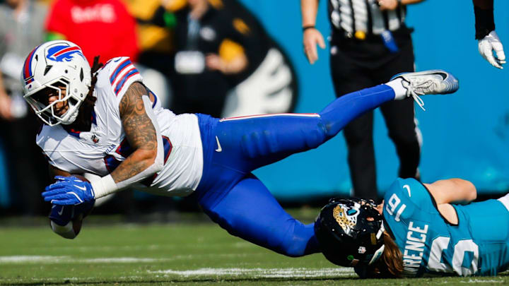 Jacksonville Jaguars quarterback Trevor Lawrence (16) tackles Buffalo Bills linebacker Shaq Thompson (45) after throwing an interception during the first quarter in an NFL football AFC Wild Card playoff matchup, Sunday, Jan. 11, 2026, in Jacksonville, Fla. Bills lead 10-7 at the half over the Jaguars. [Doug Engle/Florida Times-Union]