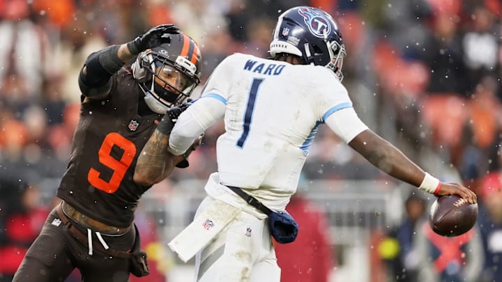 Tennessee Titans quarterback Cam Ward (1) evades Cleveland Browns safety Grant Delpit (9) Tennessee Titans quarterback Cam Ward (1) evades Cleveland Browns safety Grant Delpit (9)