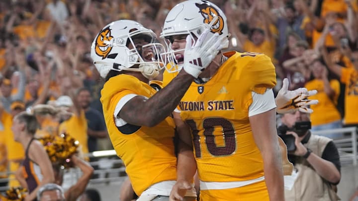 Arizona State quarterback Sam Leavitt (10) celebrates his touchdown run with teammate Jordyn Tyson (0) against the Mississippi State Bulldogs at Mountain America Stadium in Tempe on Sept. 7, 2024.