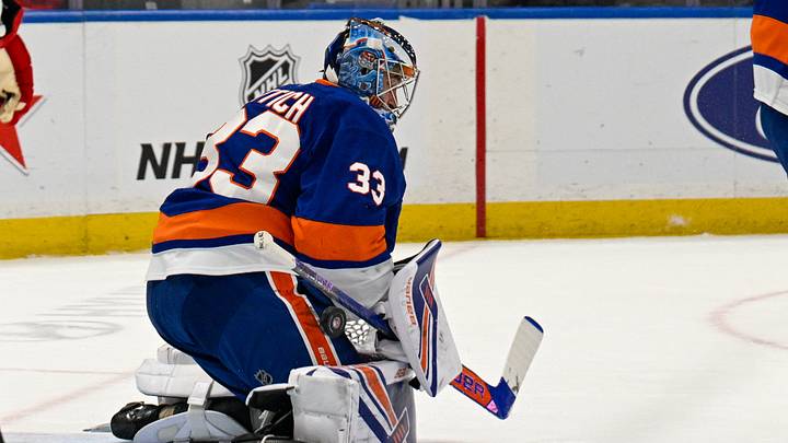 New York Islanders goaltender David Rittich (33) makes a save against the New Jersey Devils during the first period at UBS Arena. Mandatory Credit: Dennis Schneidler-Imagn Images