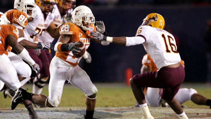 December 27, 2007; San Diego, CA, USA; Texas Longhorns cornerback Brandon Foster (28) runs the ball against the defense of Arizona State Sun Devils wide receiver Nate Kimbrough (16) after picking off a pass intended for wide receiver Kyle Williams (not pictured) in the second half during the Holiday Bowl at Qualcomm Stadium.  Texas defeated Arizona State 52-34. Mandatory Credit: Gary A. Vasquez-Imagn Images