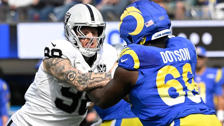 Oct 20, 2024; Inglewood, California, USA; Las Vegas Raiders defensive end Maxx Crosby (98) and Los Angeles Rams guard Kevin Dotson (69) during an NFL game at SoFi Stadium. Mandatory Credit: Robert Hanashiro-Imagn Images