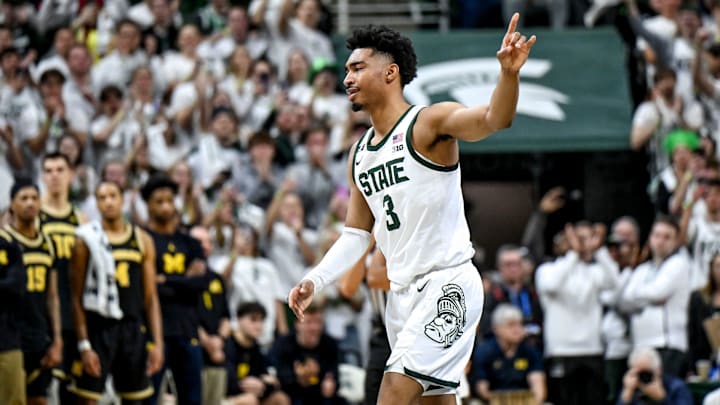 Michigan State's Jaden Akins acknowledges the fans after kissing the Spartans logo before getting subbed out late during the second half in the game against Michigan 