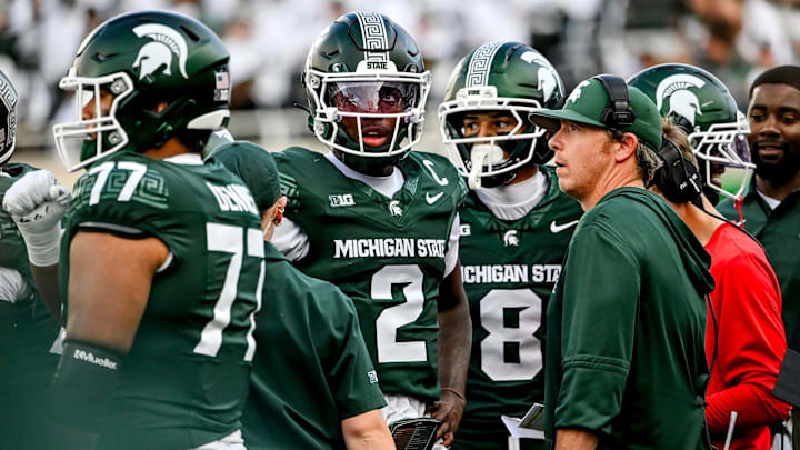 Michigan State's Aidan Chiles, left, and quarterbacks coach Jon Boyer meet on the sideline during the fourth quarter in the game against Youngstown State on Saturday, Sept. 13, 2025, at Spartan Stadium in East Lansing.