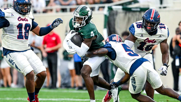 Michigan State's Jaron Glover, left, runs after a catch as Florida Atlantic's Jayden Williams closes in during the first quarter on Friday, Aug. 30, 2024, at Spartan Stadium in East Lansing.