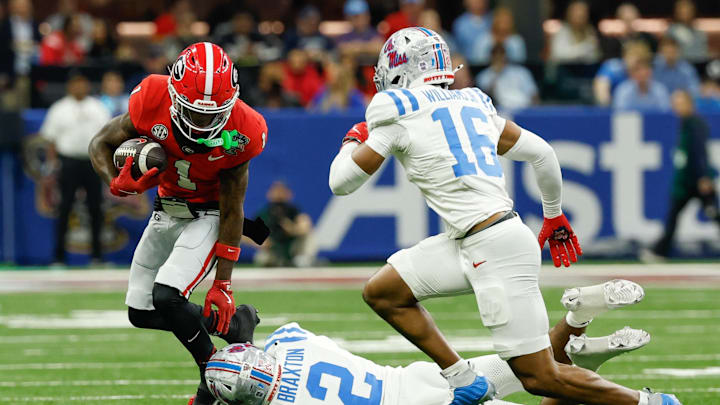 Jan 1, 2026; New Orleans, LA, USA; Georgia Bulldogs wide receiver Zachariah Branch (1) carries the ball defended by Mississippi Rebels cornerback Jaylon Braxton (2) and safety Wydett Williams Jr. (16) in the first quarter during the 2025 Sugar Bowl and quarterfinal game of the College Football Playoff at Caesars Superdome. Mandatory Credit: Geoff Burke-Imagn Images
