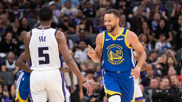 Oct 9, 2024; Sacramento, California, USA; Golden State Warriors guard Stephen Curry (30) motions to Sacramento Kings guard De'Aaron Fox (5) after scoring during the second quarter at Golden 1 Center. Mandatory Credit: Ed Szczepanski-Imagn Images
