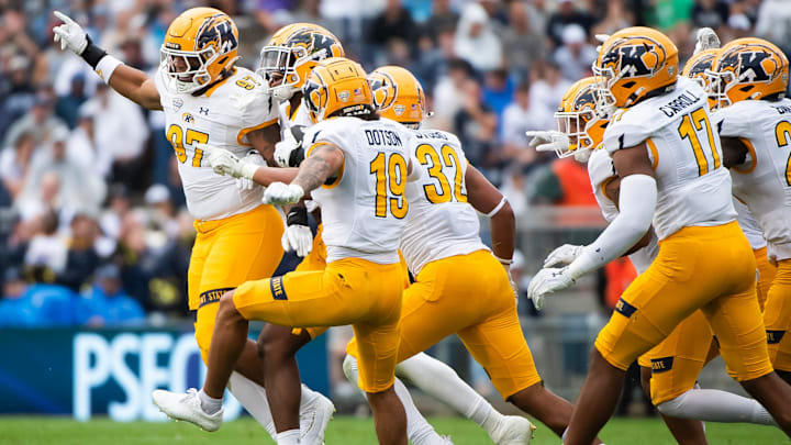 Kent State defensive end Kameron Olds, second from left, celebrates with his teammates after intercepting a pass in the first half of an NCAA football game against Penn State, Saturday, Sept. 21, 2024, in State College, Pa.