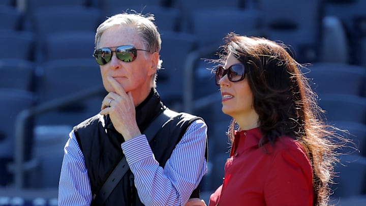 Oct 1, 2025; Bronx, New York, USA; Boston Red Sox owner John Henry (left) stands on the field with his wife Linda Pizzuti Henry during batting practice before game two of the Wildcard round of the 2025 MLB playoffs against the New York Yankees at Yankee Stadium. Mandatory Credit: Brad Penner-Imagn Images