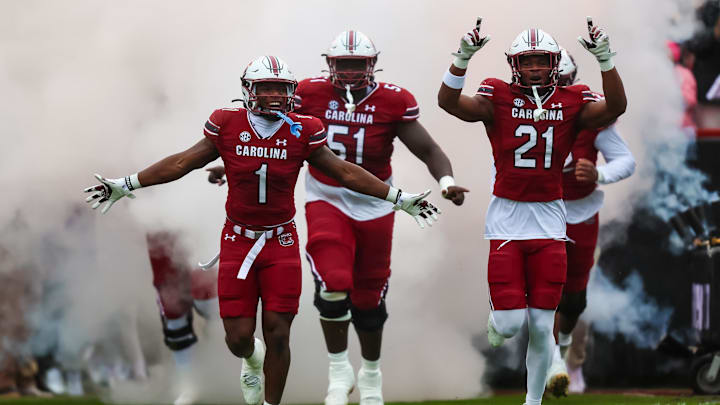 South Carolina football players DQ Smith (1), Nick Emmanwori (21), and Tree Babalade (51) running out of the tunnel last year