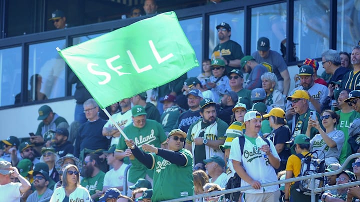 An Oakland Athletics fan waves a flag before the game against the Texas Rangers at Oakland-Alameda County Coliseum.
