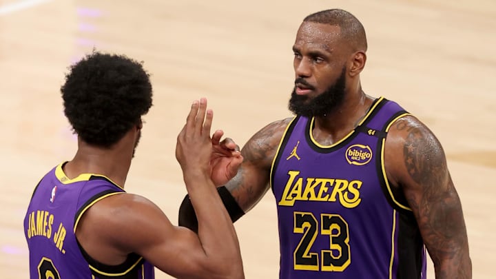 Feb 1, 2025; New York, New York, USA: Los Angeles Lakers guard Bronny James (9) checks in for forward LeBron James (23) during the fourth quarter against the New York Knicks at Madison Square Garden. Mandatory Credit: Brad Penner-Imagn Images
