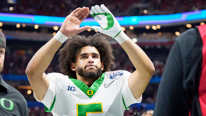 Once a Duck, but how long a Duck: Oregon quarterback Dante Moore walks off the field as the Oregon Ducks face the Indiana Hoosiers in the Peach Bowl on Jan. 9, 2026, at Mercedes-Benz Stadium in Atlanta, Georgia.