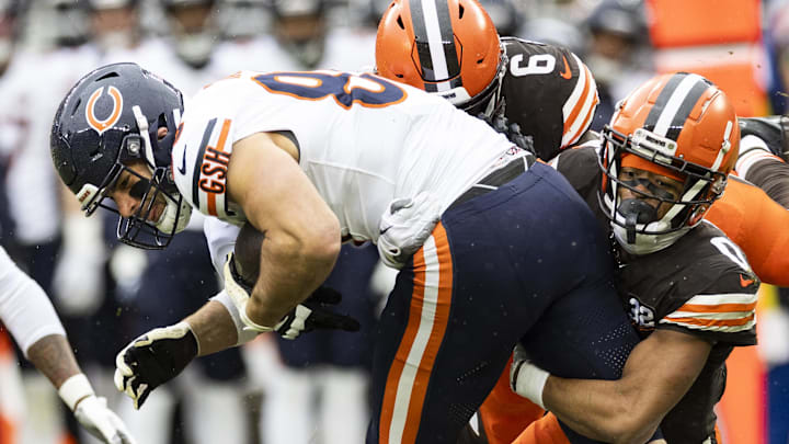 Cole Kmet tucks it and plows for more yards after a catch against Cleveland. Cole Kmet tucks it and plows for more yards after a catch against Cleveland.