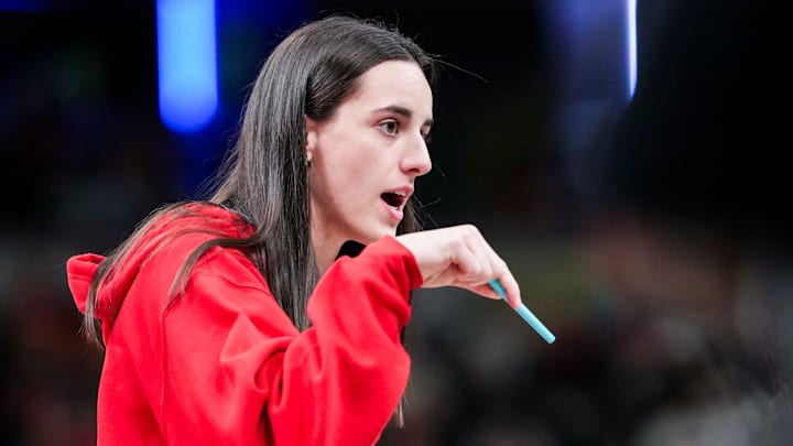Indiana Fever guard Caitlin Clark (22) talks with an official during a timeout Tuesday, June 3, 2025, at a game between the Indiana Fever and the Washington Mystics at Gainbridge Fieldhouse in Indianapolis.
