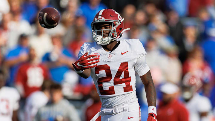 Nov 11, 2023; Lexington, Kentucky, USA; Alabama Crimson Tide wide receiver Emmanuel Henderson Jr. (24) passes the ball to a referee during the second quarter against the Kentucky Wildcats at Kroger Field. Mandatory Credit: Jordan Prather-Imagn Images