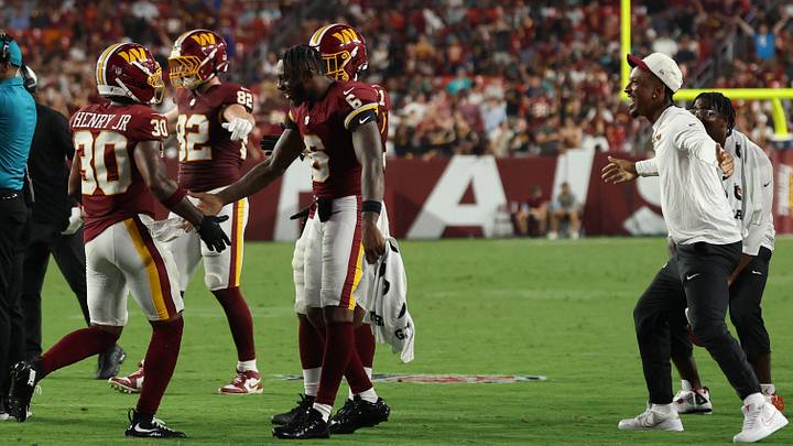 Aug 14, 2026; Landover, Maryland, USA; Washington Commanders quarterback Jayden Daniels (R) waits to celebrate with Commanders running back Robert Henry Jr. (30) after a touchdown against the Miami Dolphins during the first half at Northwest Stadium. Mandatory Credit: Geoff Burke-Imagn Images Aug 14, 2026; Landover, Maryland, USA; Washington Commanders quarterback Jayden Daniels (R) waits to celebrate with Commanders running back Robert Henry Jr. (30) after a touchdown against the Miami Dolphins during the first half at Northwest Stadium. Mandatory Credit: Geoff Burke-Imagn Images