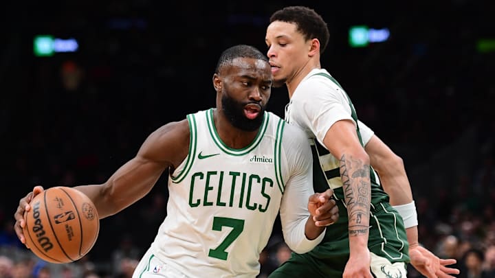 Feb 1, 2026; Boston, Massachusetts, USA; Boston Celtics guard Jaylen Brown (7) controls the ball while Milwaukee Bucks guard Ryan Rollins (13) defends during the second half at TD Garden. Mandatory Credit: Bob DeChiara-Imagn Images