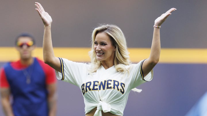 Jun 16, 2023; Milwaukee, Wisconsin, USA; Paige Spiranac waves to the crowd after throwing out a first pitch prior to the game between the Pittsburgh Pirates and Milwaukee Brewers at American Family Field. Jun 16, 2023; Milwaukee, Wisconsin, USA; Paige Spiranac waves to the crowd after throwing out a first pitch prior to the game between the Pittsburgh Pirates and Milwaukee Brewers at American Family Field.