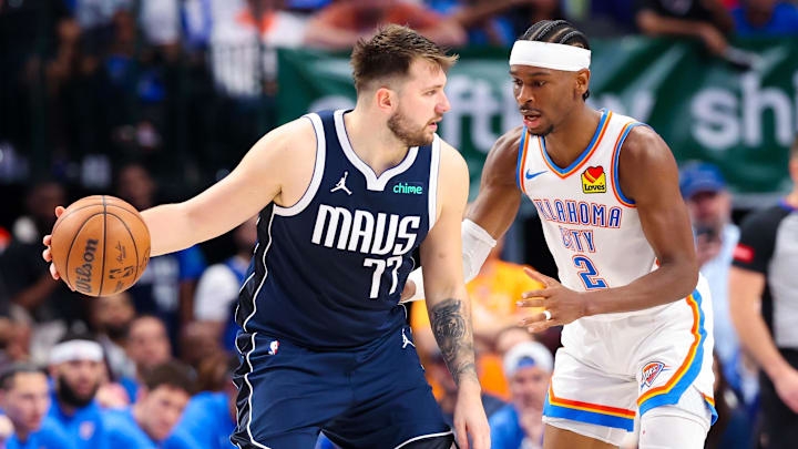 May 11, 2024; Dallas, Texas, USA; Dallas Mavericks guard Luka Doncic (77) controls the ball as Oklahoma City Thunder guard Shai Gilgeous-Alexander (2) defends during the second half during game three of the second round for the 2024 NBA playoffs at American Airlines Center. Mandatory Credit: Kevin Jairaj-Imagn Images